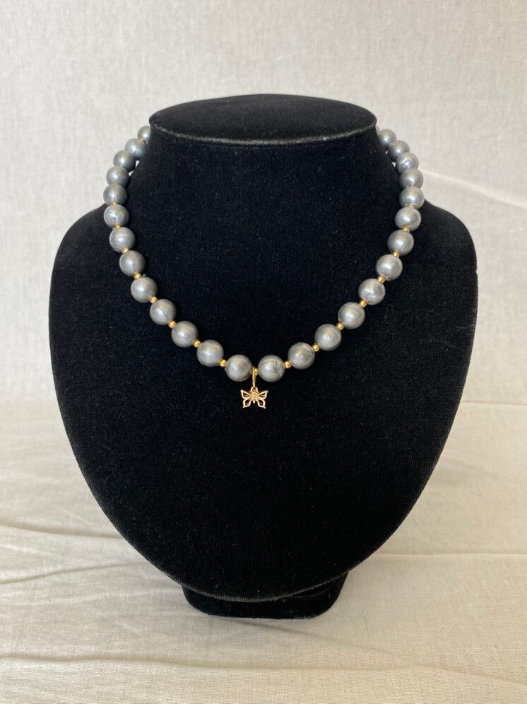 Up-cycled faux pearl necklace with butterfly pendant