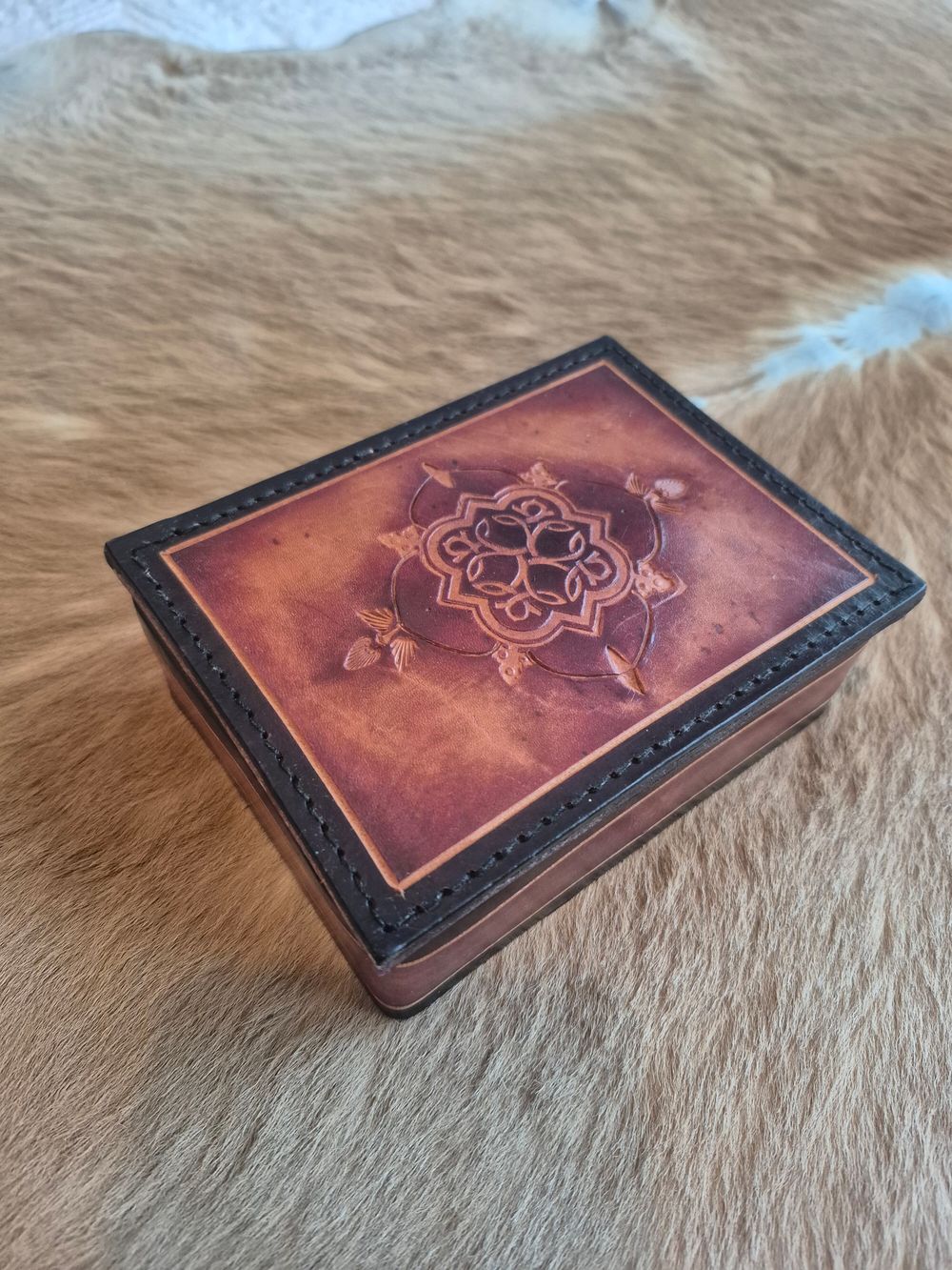 Handmade Tooled Leather Jewelery Box with Red interior fabric.