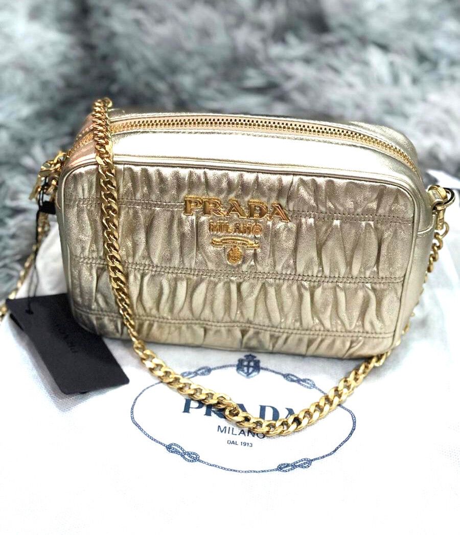 PRADA GOLD CAMERA SLING BAG