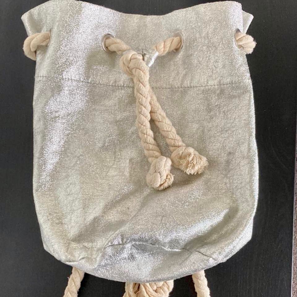 ✨ Silver Boho Backpack ✨ Festival & Beach Essential  A unique preloved piece with that effortless boho energy. This silver backpack brings texture, personality and a laid-back luxe vibe, perfect for festivals, beach days or everyday styling with a twist. 