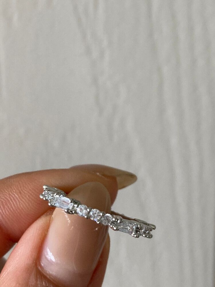 ✨ Silver Plated Zircon Eternity Band ✨ Size: 6 Crafted from high-quality copper with a durable PVC coating and finished in elegant silver plating, this eternity band is designed to dazzle. Featuring a delicate mix of round and baguette zircon stones, it’s