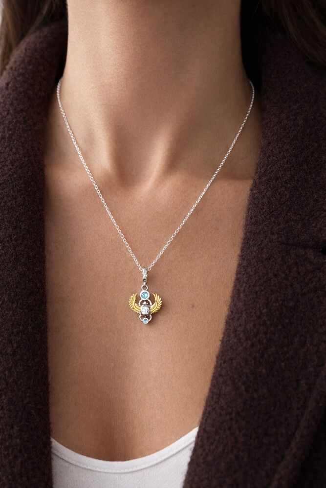 ✨ Egyptian Scarab Charm Pendant – 925 Sterling Silver & Gold Wing Detail ✨  This stunning Egyptian-inspired scarab charm is crafted in genuine 925 sterling silver, featuring intricate detailing with radiant gold-tone wings and sparkling blue zircon stones