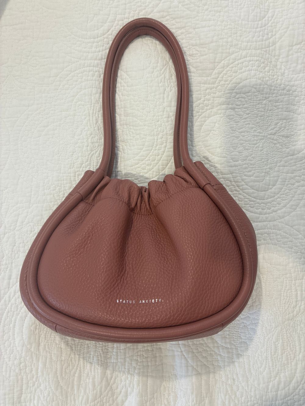 Status Anxiety ordinary pleasures dusty rose bag