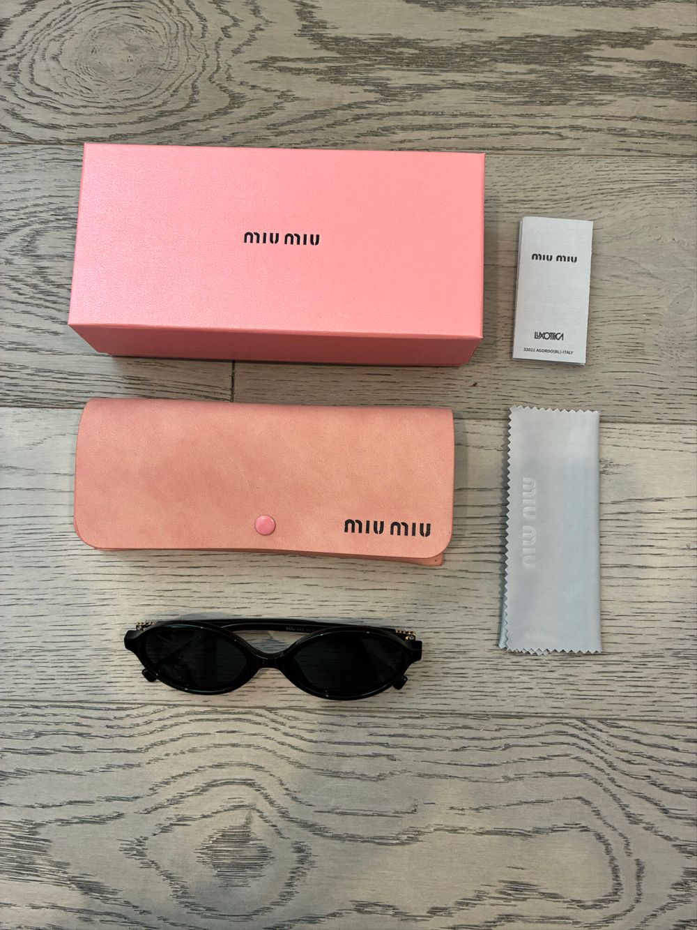 Miu Miu Black Oval Sunglasses