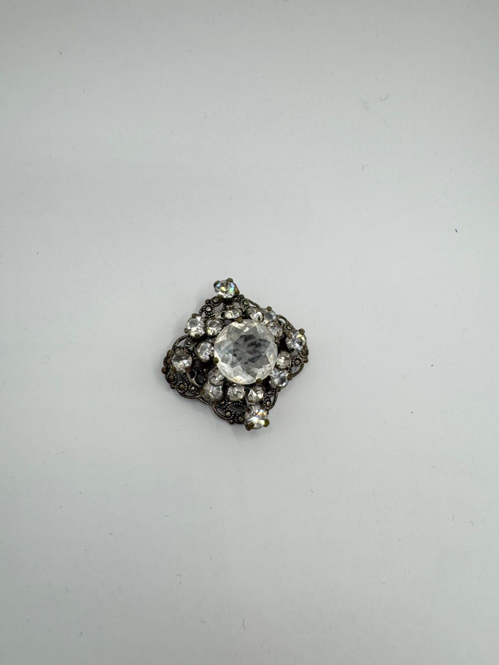 Early Century brooch - clear crystal and silver tone - clasp dates it to early-mid century 30mm - filigree design