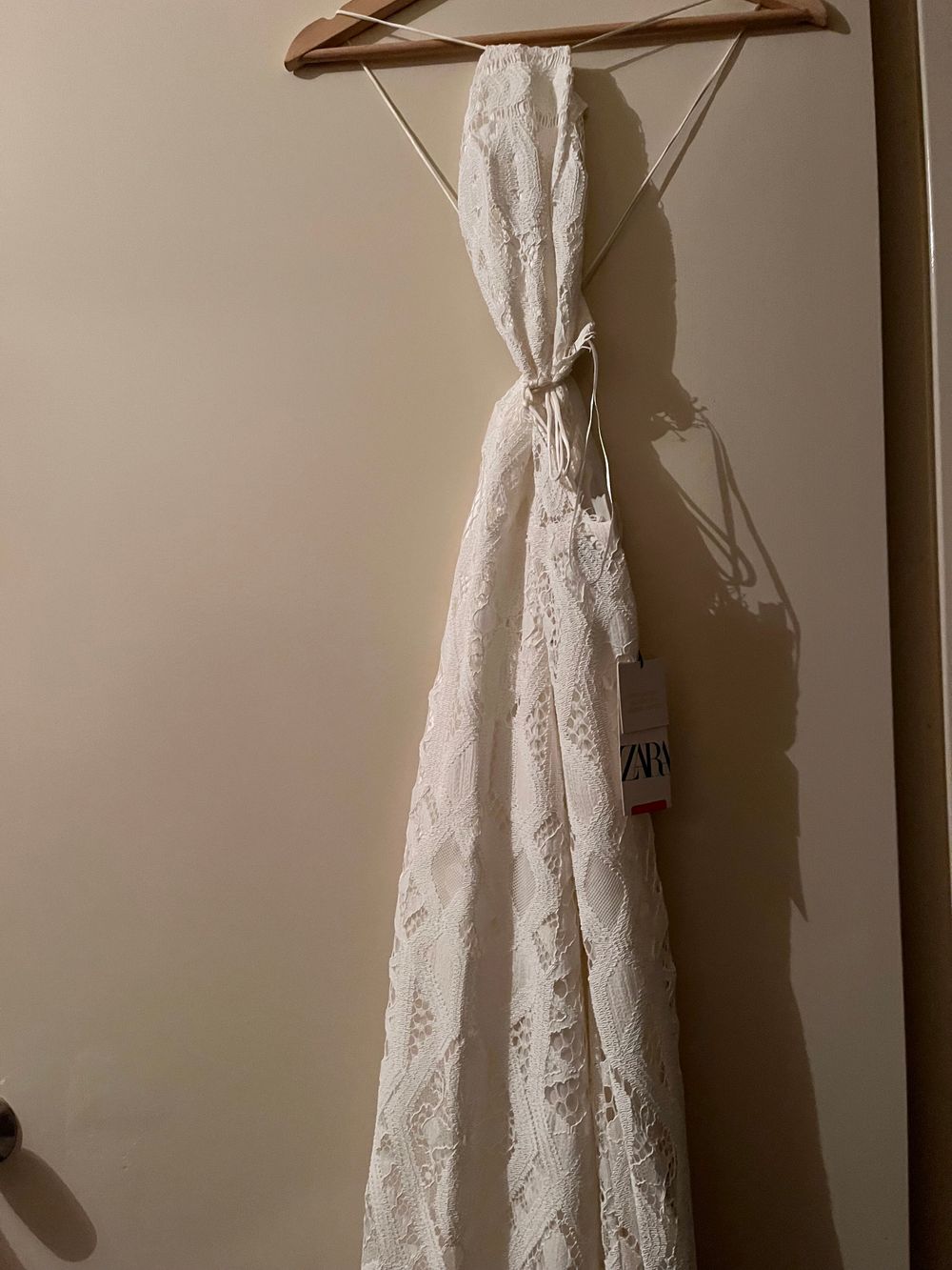 long/mid length white dress with step over low back