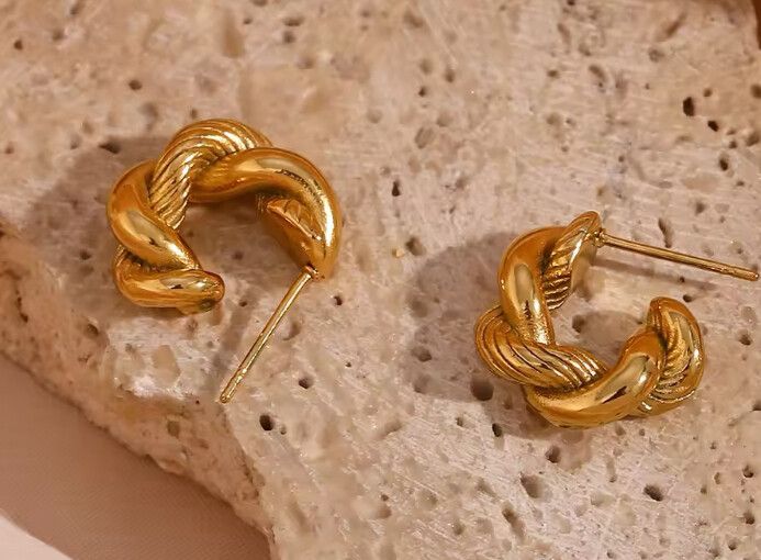 ✨Twisted Knot Earrings✨  Sleek and bold, these twisted knot earrings are crafted from 18k gold-filled stainless steel, offering a luxe look without compromise. Hypoallergenic, waterproof, and tarnish-free, they ensure comfort and long-lasting shine. Their