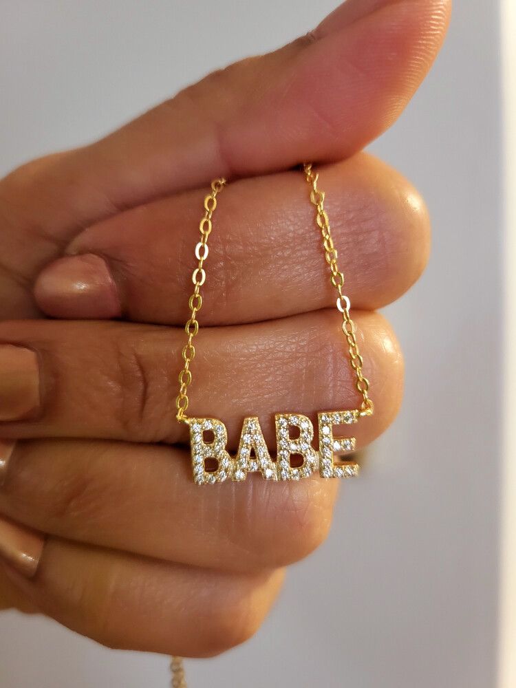 ✨ BABE Necklace in 14k Gold Plated Silver ✨  Shine like the icon you are with this sparkling BABE necklace — crafted from real 925 sterling silver and plated with luxurious 14k gold. The bold crystal-studded lettering adds that perfect girly touch, flirty
