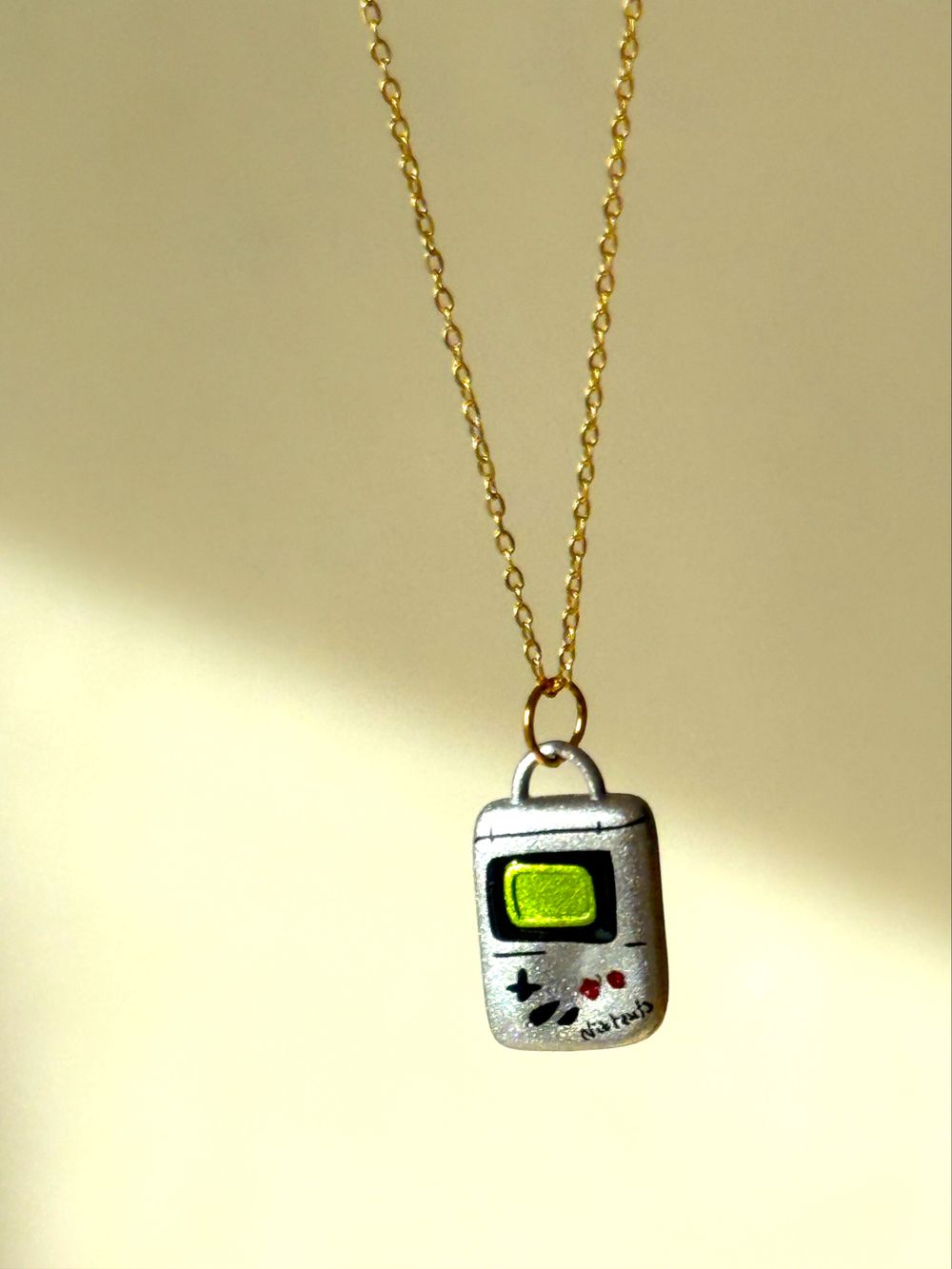 ✨ Retro Game Console Necklace Y2K Nostalgia Gamer Girl Aesthetic ✨  Such a fun conversation-piece necklace inspired by old school handheld gaming consoles. Perfect if you love that early 2000s nostalgia, retro tech vibes, indie girl style or playful state
